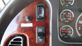 Close-up of the dashboard controls in a 2017 Freightliner M2 106 featuring speed control cruise control and gauge displays for oil water and transmission temperatures