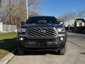 Front view of a dark gray 2021 Toyota Tacoma with a distinctive grille and bold headlights