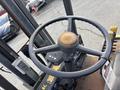 A close-up view of the steering wheel and control panel of a 2000 Clark GPS 15 forklift