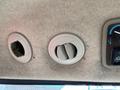 Interior air vents of a 2014 John Deere 1585 Terrain Cut with a circular design and adjustable slats for airflow regulation