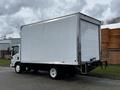 A 2018 Isuzu NRR box truck with a white exterior and a large cargo area on the back