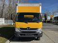 A yellow 2017 Hino 155 box truck facing forward with a large cargo area and two side mirrors