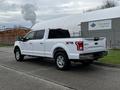 A white 2017 Ford F-150 XTR truck parked with its rear visible showcasing chrome accents and a spacious cab