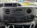 Dashboard of a 2009 Ford Econoline featuring air vents a radio display and various controls including knobs and buttons
