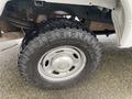 A close-up of a 2017 Ford F-250 SD tire featuring an off-road tread pattern and a silver wheel with the Ford logo