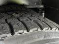 Close-up of a tire from a 2017 Chevrolet Express showing tread patterns with some dirt and debris visible on the surface