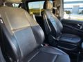 Two black leather front seats of a 2022 Mercedes-Benz Metris are shown with high backs and armrests