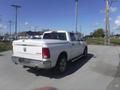 A white 2019 RAM 1500 Classic Eco Diesel pickup truck parked on a road showing the rear and side profile with a tonneau cover on the truck bed