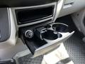 A black cup holder drawer pulled out from the dashboard of a 2017 Mercedes-Benz Sprinter with a circular power outlet beside it
