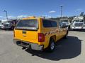 2013 Chevrolet Silverado 1500 in bright yellow with a canopy and reflective stripes on the sides