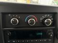 Close-up of the control panel in a 2020 Chevrolet Express featuring climate control knobs and a digital clock display