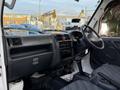 Interior view of a 2008 Suzuki Carry showing the dashboard gear shift and seats in a grey fabric