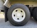 Close-up of a tire mounted on a 2009 International 7500 featuring a white rim with multiple lug nut holes and rugged tread pattern
