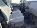 Interior of a 2015 Ford F-450 SD showing two gray cloth front seats with a dashboard and console visible