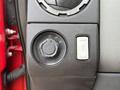 A close-up of a 2013 Ford F-550 control module featuring a circular switch with settings for lights and a rectangular button beside it