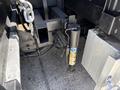 A close-up view of the hitch and suspension components of a 2012 Ford F-450 SD with various mechanical parts visible