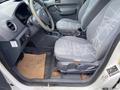 Interior of a 2013 Ford Transit Connect featuring two fabric-covered front seats with a gray geometric pattern and a steering wheel