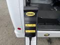 A hand-held control panel with buttons labeled Stow Deploy Up and Down designed for operating a lift system in a 2013 Chevrolet Express van