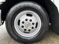 A close-up of the wheel of a 2013 Chevrolet Express featuring a silver rim with a Chevrolet logo and a black tire with the word RADAR visible on the sidewall