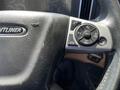Close-up of the steering wheel of a 2022 Freightliner Cascadia with control buttons for cruise and other functions visible
