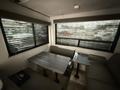Interior of a 2022 Keystone Hideout RDWE 20RDWE travel trailer featuring a table and seating area with dark window shades