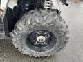 A large, rugged tire from a 2017 Polaris Scrambler featuring deep treads and a black metal rim with visible bolts