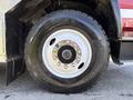 Close-up of a black tire mounted on a silver rim with visible lug nuts on a 1994 Volvo FE 42