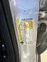 A label detailing specifications and safety information for a 2014 Ford Escape mounted on the driver's side door jamb