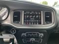 A 2022 Dodge Charger interior featuring a digital dashboard display with climate controls and audio system settings