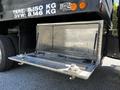 A metal storage compartment is open on the rear of a 2015 RAM 5500 truck showcasing a durable interior designed for carrying equipment or tools