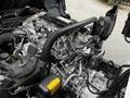 Engine of a 2014 Hino 195 with various metal components and hydraulic systems visible