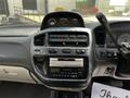 Interior dashboard of a 2003 Mitsubishi Delica featuring gauges a car stereo and climate control buttons
