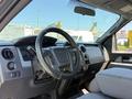 Interior view of a 2014 Ford F-150 showing the steering wheel dashboard and center console with controls and upholstery seats