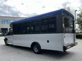 A 2019 Chevrolet Express bus with a blue and gray exterior featuring large windows and a rear entry door