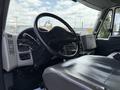 Interior view of a 2014 International TerraStar truck showing the steering wheel dashboard and driver seat