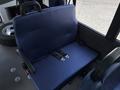A blue bench seat with black seat belts in a vehicle interior designed for passenger comfort and safety