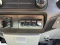 A close-up view of the control panel in a 2014 Ford F-250 SD featuring four auxiliary switches labeled AUX 1 AUX 2 AUX 3 and AUX 4