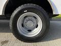 A close-up view of the wheel of a 2018 Ford F-550 featuring a silver rim and a large black tire with deep treads