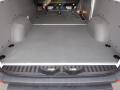 Interior view of a 2016 Mercedes-Benz Sprinter cargo area featuring a flat floor with two molded wheel wells and securing points for cargo stability