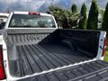 A 2017 GMC Sierra 1500 truck bed featuring a textured surface with the GMC logo prominently displayed on the side