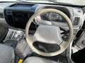 Interior view of a 2004 Toyota Toyoace showing the steering wheel gear shift and instrument panel