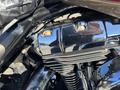 Close-up of a chrome engine cover and cylinder of a 2004 Harley-Davidson FLHTCUI showcasing detailed metalwork and mechanics