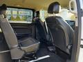 Interior view of a 2022 Mercedes-Benz Metris showing the second row of black leather seats and spacious seating arrangement