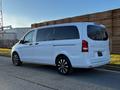 A 2022 Mercedes-Benz Metris van in white with black wheels parked on a road showcasing its sleek design and spacious rear features