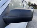 Close-up of the side mirror of a 2017 GMC Sierra 1500 showing a black casing and water spots on the surface