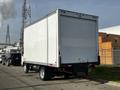 A 2015 Hino 195 box truck with a white exterior and no visible markings parked in an industrial setting