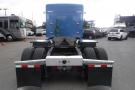 Rear view of a 2015 Kenworth T660 truck with dual rear tires and a blue cab showing exposed truck frame and connections