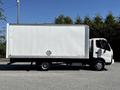 A 2020 Hino 155 truck with a white box cargo area and a black chassis parked on a surface with a plain exterior