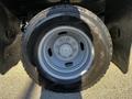 A gray wheel with a silver rim mounted on a Goodyear Wrangler tire designed for a 2011 Ford F-350 SD