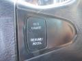 Close-up of a steering wheel control panel featuring buttons labeled SET/CRUISE and RESUME/ACCEL on a textured black surface